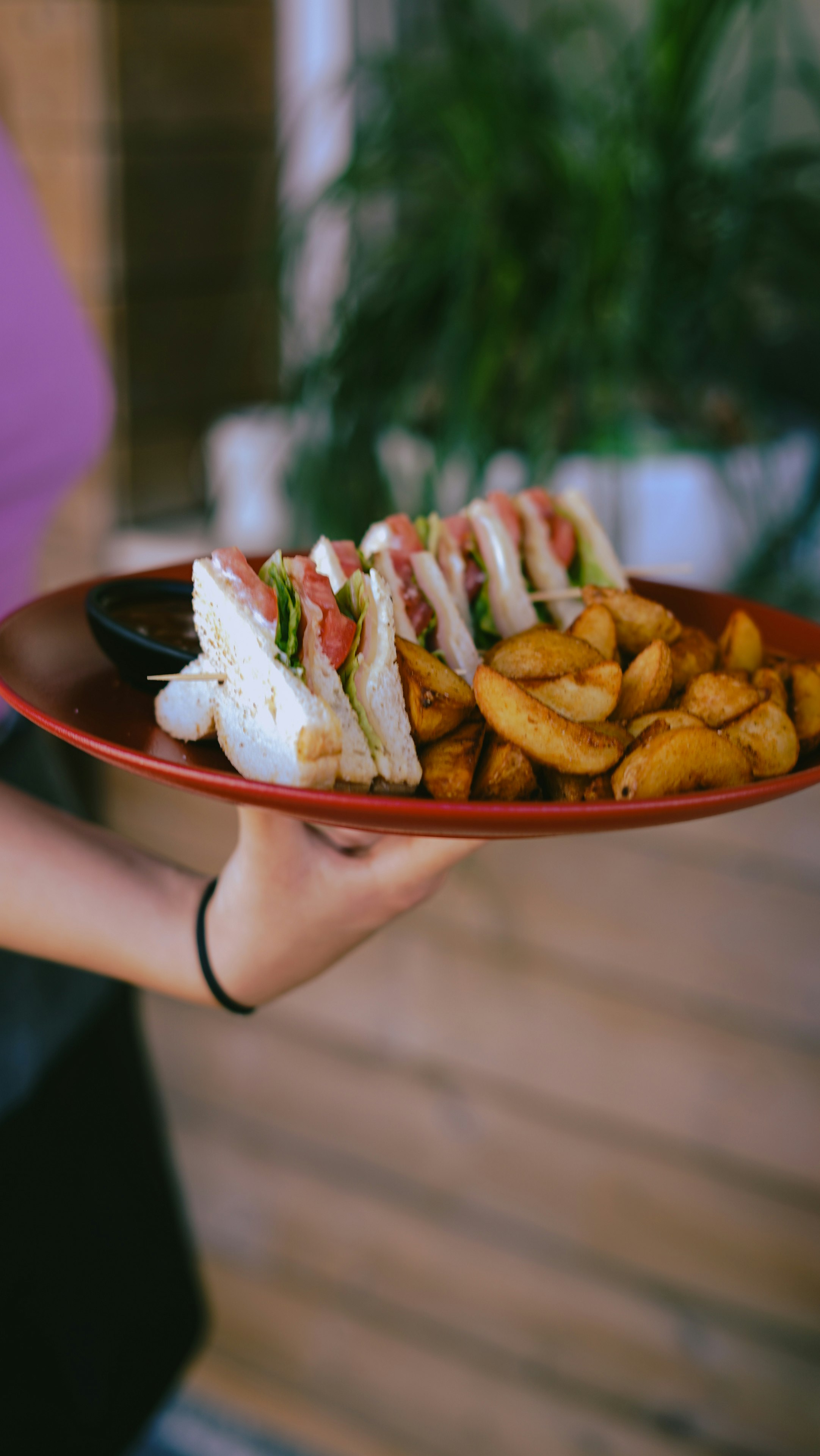 person holding white ceramic plate with sliced bread